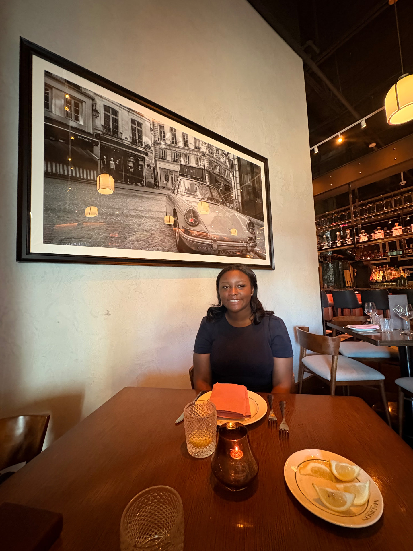 Mya smiling at a restaurant table